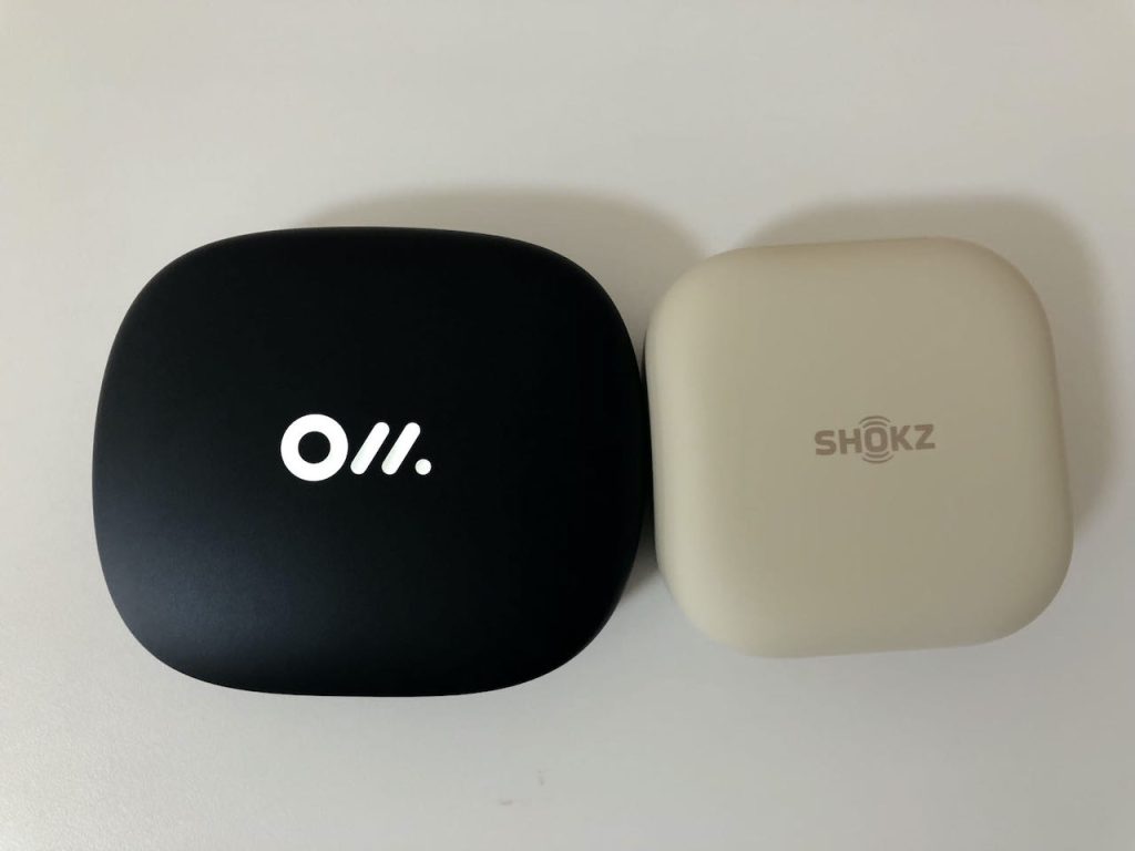 Side by side comparison of Oladance OWS Pro and Shokz OpenFit earbud cases.