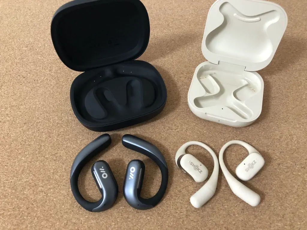 Comparative view of Oladance OWS Pro and Shokz OpenFit earbuds with their respective cases.