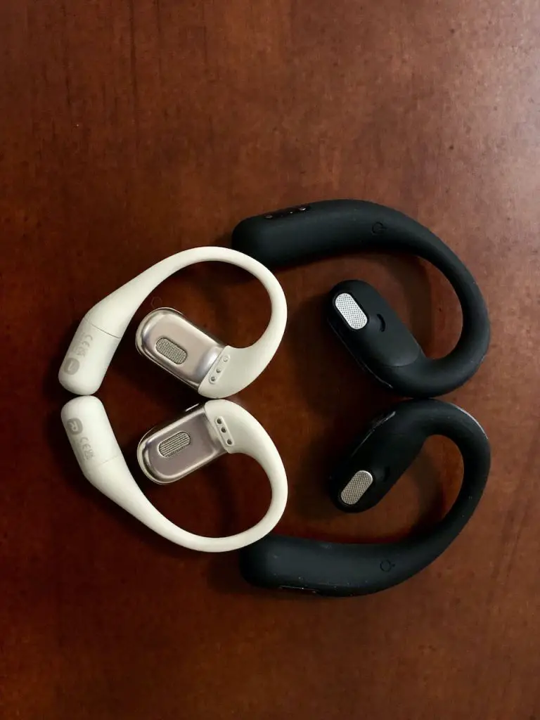 Comparative view of the ear-facing side of Oladance OWS Pro and Shokz OpenFit earbuds.