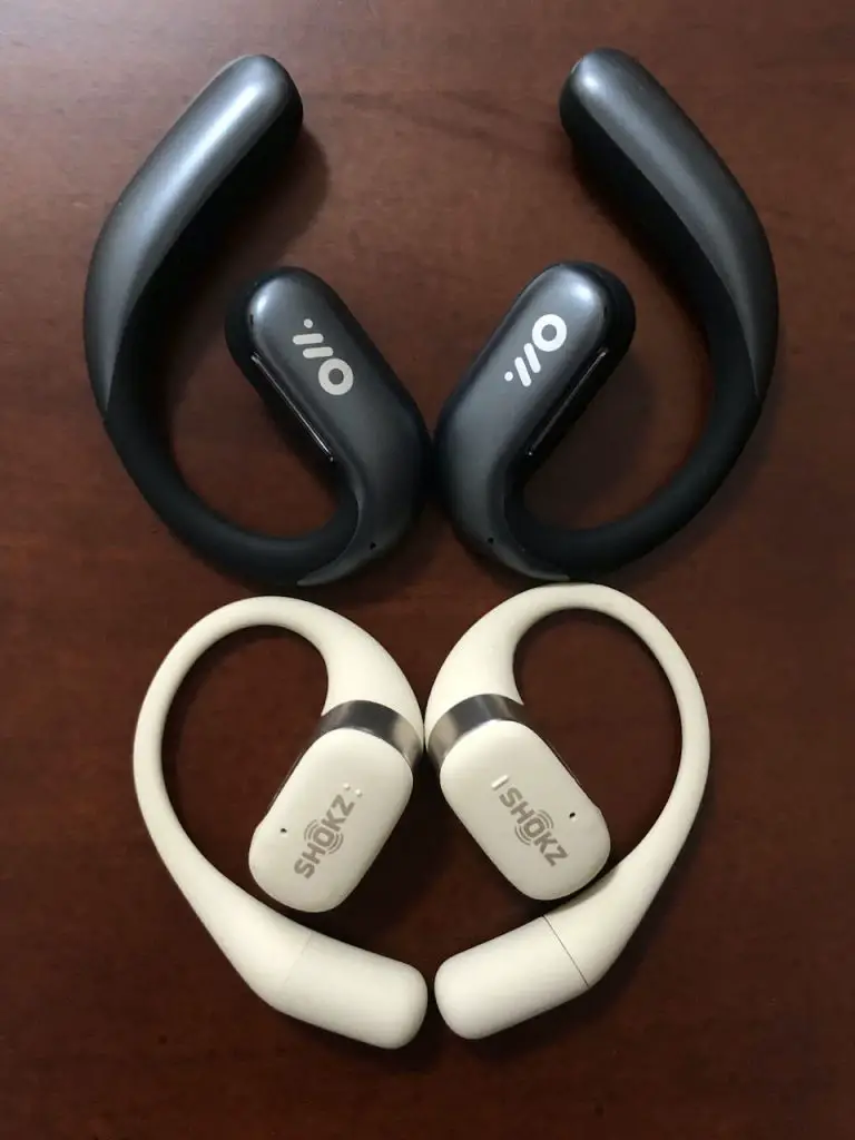 Comparative view of the outward-facing side of Oladance OWS Pro and Shokz OpenFit earbuds.